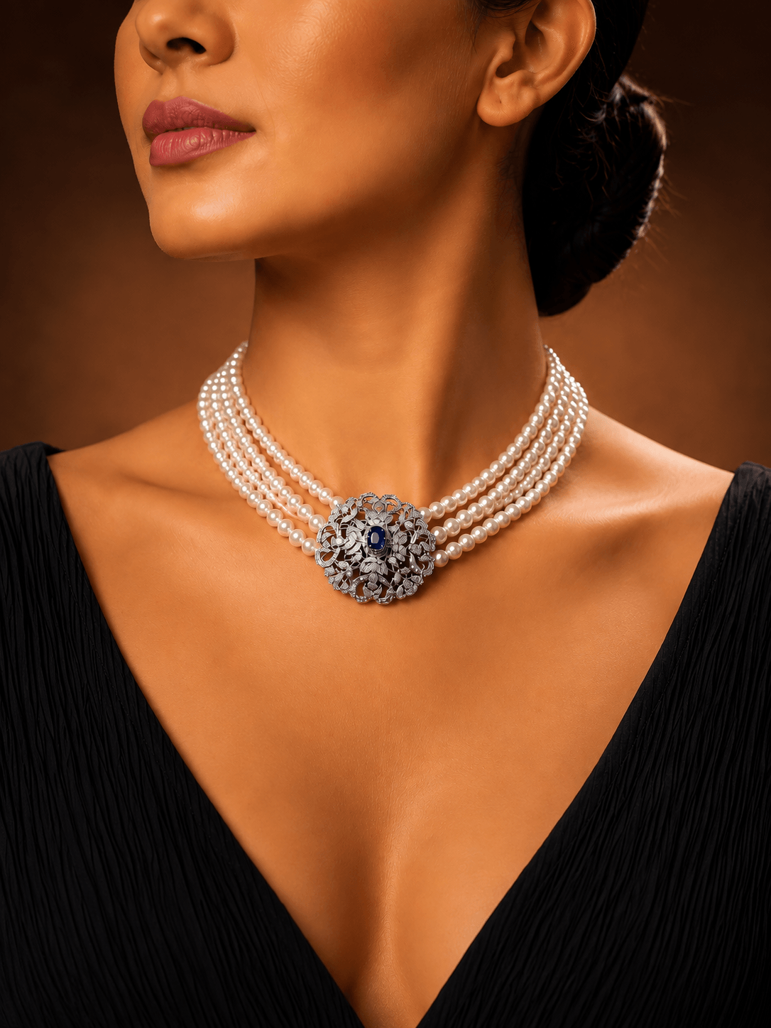 A curated fine jewellery collection — pearl and diamond choker with sapphire centrepiece at Solitaire